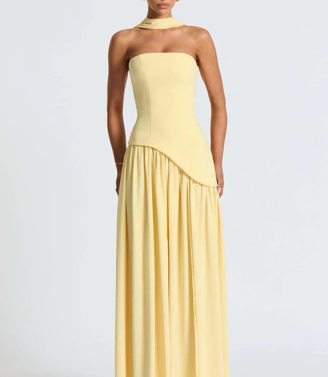 Pale yellow halter maxi dress with fitted strapless bodice and flowing skirt front view