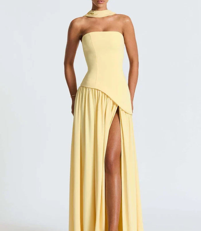 Pale yellow halter maxi dress showing the strapless bodice and high slit from the front
