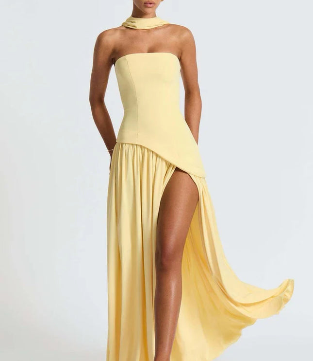 Pale yellow halter maxi dress with dramatic side drape, thigh slit, and strapless bodice side view