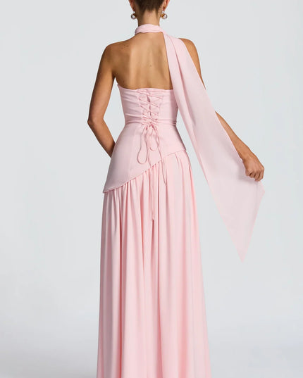 Back view of pink halter maxi dress with lace-up back, scarf tie, and long skirt