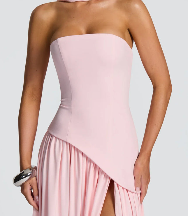 Close-up of pink strapless halter maxi dress with asymmetrical overlay and slit