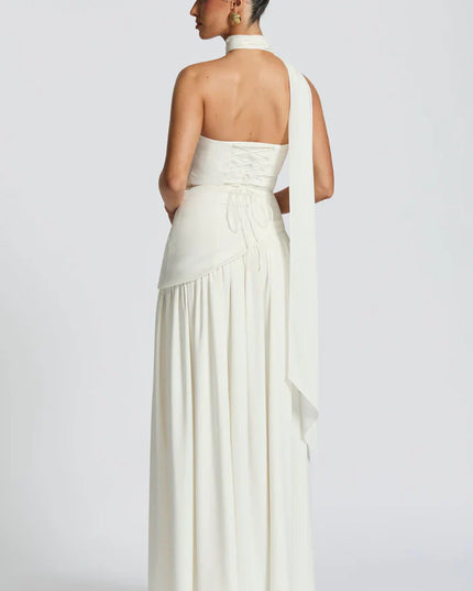 Pink halter maxi dress with strapless bodice, pleated skirt, and sheer draped scarf