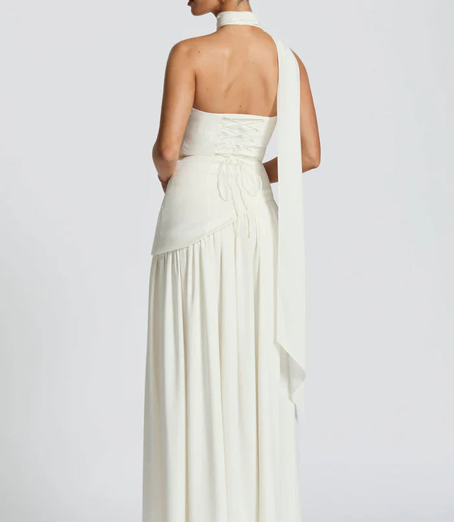 Pink halter maxi dress with strapless bodice, pleated skirt, and sheer draped scarf