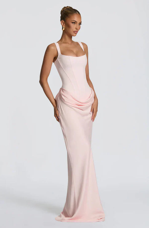 Pink square neck corset maxi dress in side angle with flowing hem