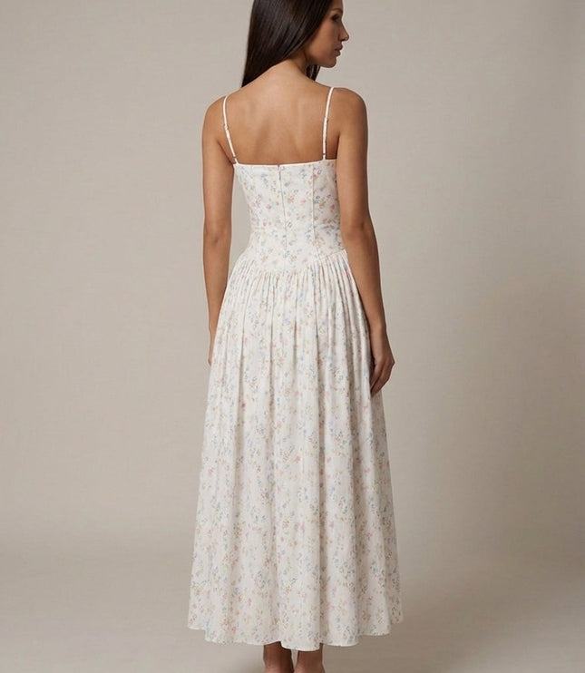 Back view of white floral corset midi dress with thin straps and gathered midi skirt