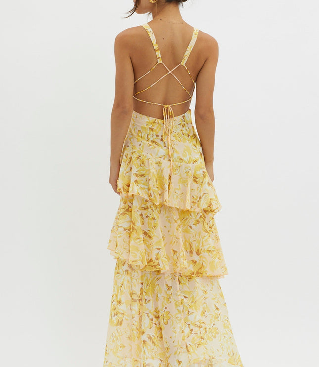 Yellow floral ruffled maxi dress back view with open back and crisscross tie straps